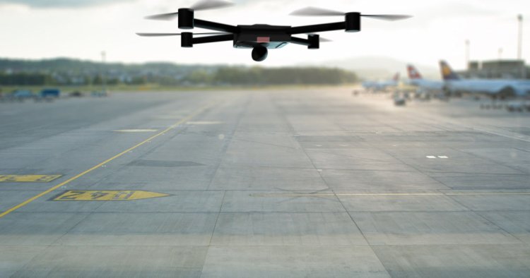drone flying above the airport runway