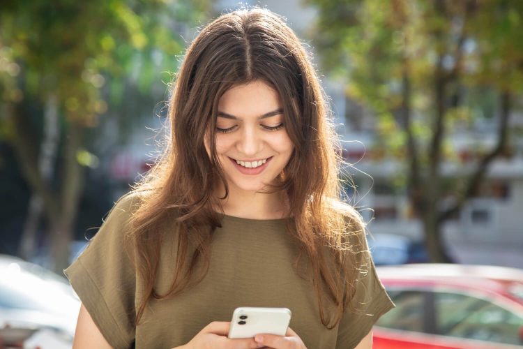 attractive young woman with smartphone background street 1
