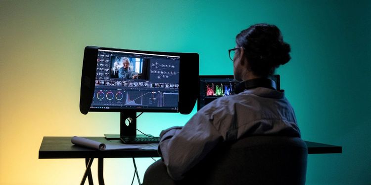 person using video editing software featured